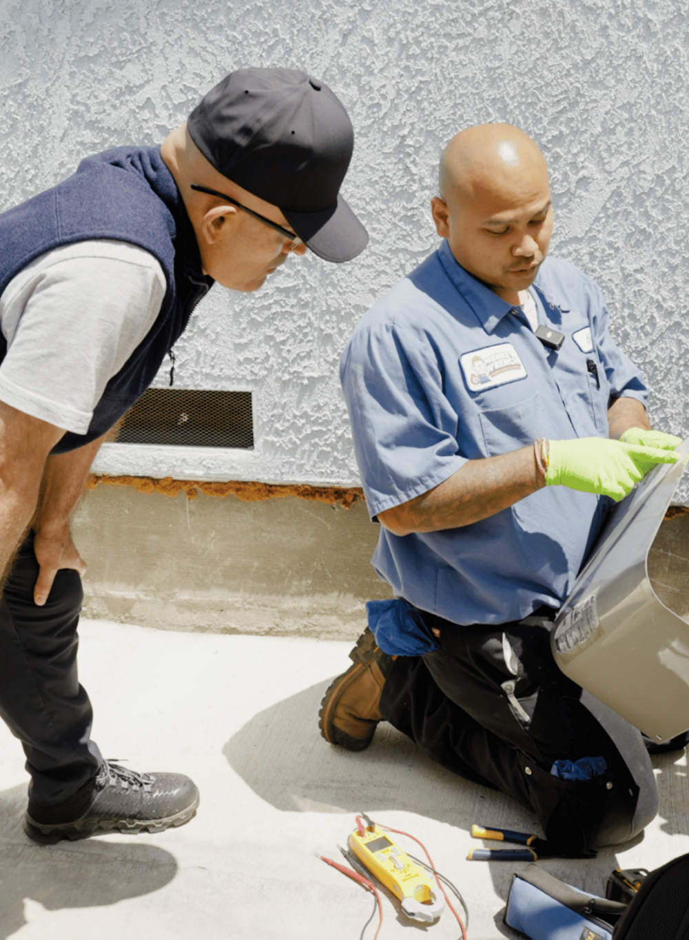 Heating & Air Technician for a Plumbing, Heating, Air & Electric Company in Los Angeles showing customer furnace and air conditioning repair