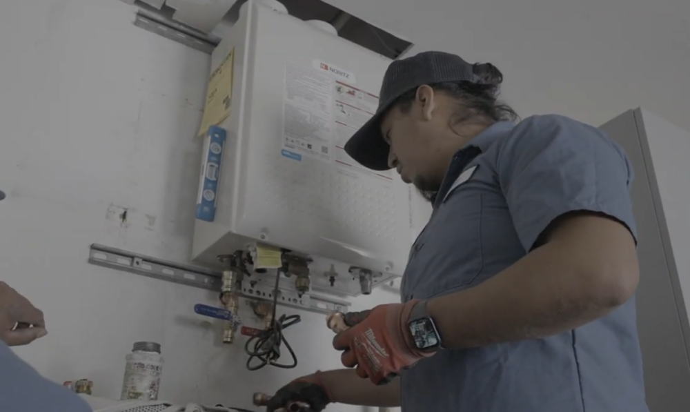 A Monkey Wrench technician finishing up a tankless water heater installation. 