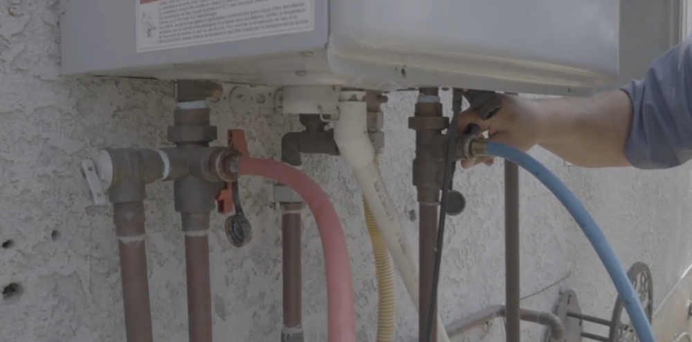 The image shows Isolation valves connecting to draining flexible pipes. 