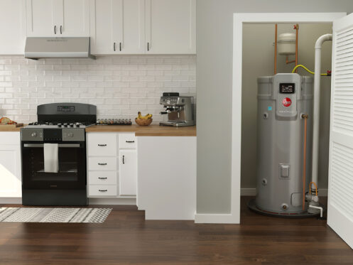 A tank-style water heater installed inside an utility closet in a home.