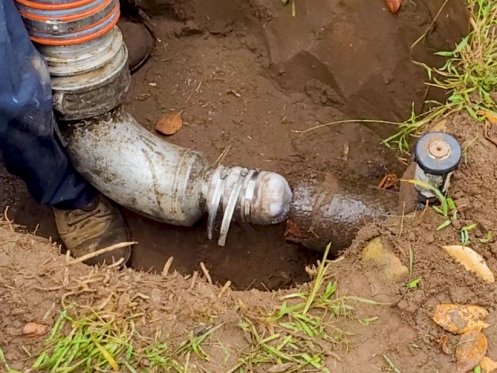 A main sewer line being serviced by a technician.