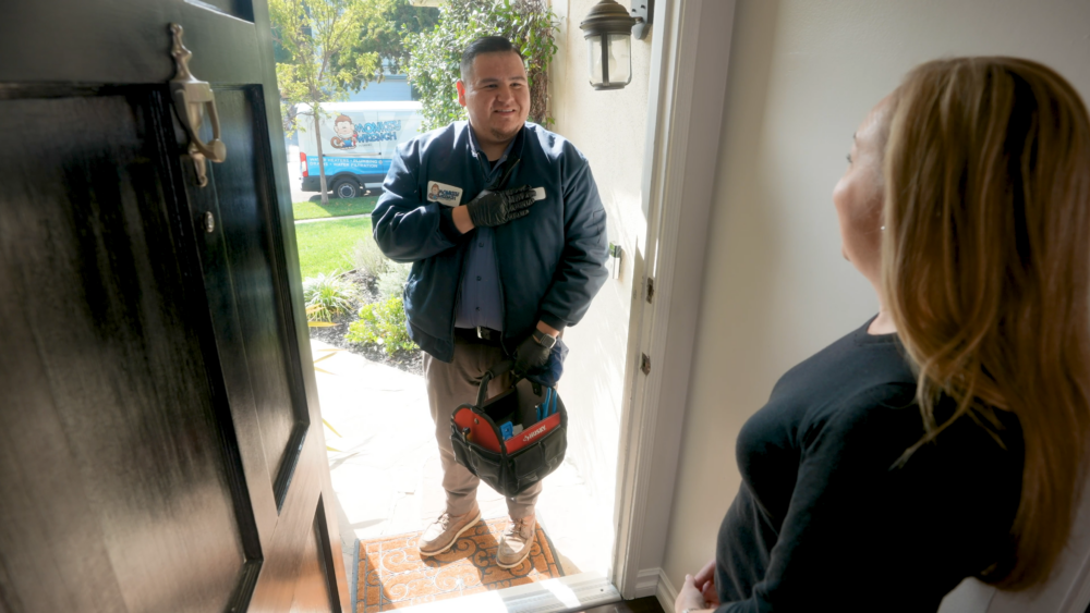 A Monkey Wrench technician introducing themselves to a homeowner.