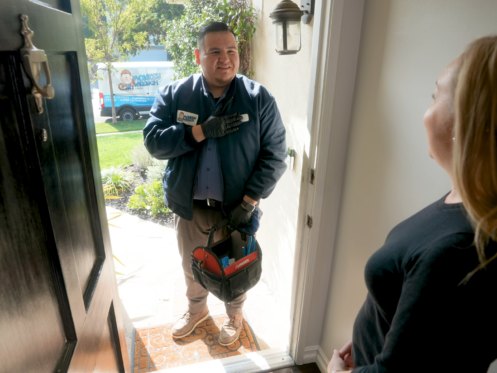 A Monkey Wrench technician introducing themselves to a homeowner.