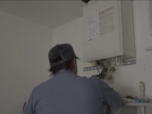 A Monkey Wrench technician finishing up a tankless water heater installation.