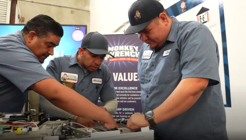 Monkey Wrench technicians inspecting the inside of a tankless water heater.