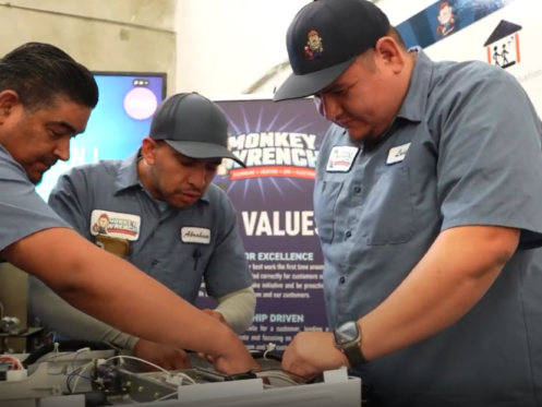 Monkey Wrench technicians inspecting the inside of a tankless water heater.