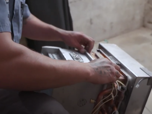 A Monkey Wrench technician performing a tankless water heater rebuild.