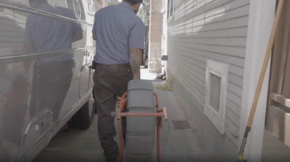 A Monkey Wrench moving a camera line system in a home's driveway.