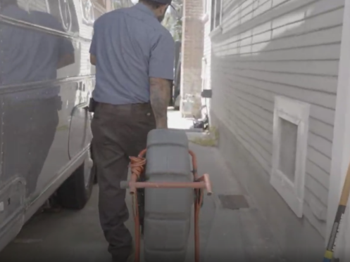 A Monkey Wrench moving a camera line system in a home's driveway.