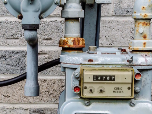 The image shows a gas meter outside a home.