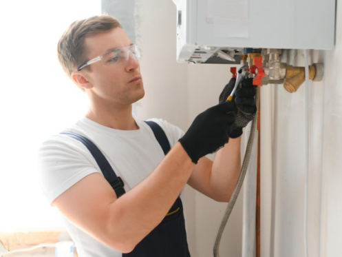 The image shows a technician servicing a tankless water heater.