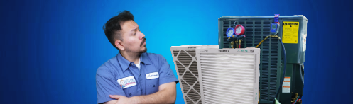 The image shows a technician looking at items for heat pump maintenance.